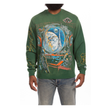 Green long-sleeve shirt with space-themed design worn by a person on a green background